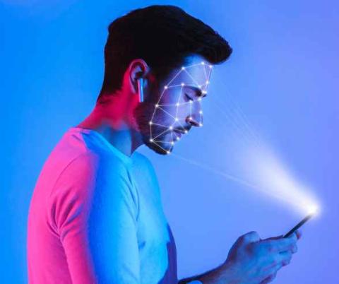 man with phone face scan